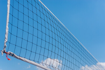 Volleyball net on blue sky background.