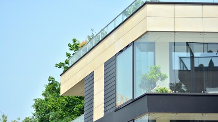 Fototapeta premium Eco architecture. Green tree and apartment building. The harmony of nature and modernity.