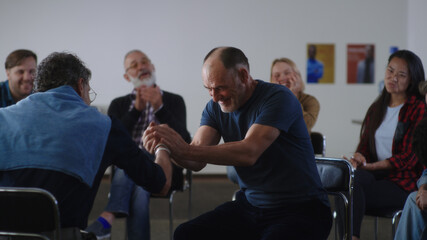 Happy Aged man sharing story of successful addiction overcoming