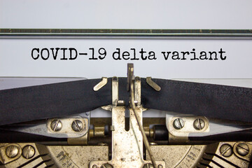 Covid-19 delta virus variant symbol. Words 'Covid-19 delta variant' typed on retro typewriter. Medical and COVID-19 new delta plus variant concept.