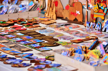 A counter with wooden souvenir magnets with city attractions for tourists. Russia Kazan 24.04.2021. High quality photo