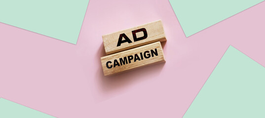 Ad Campaign on Wooden Blocks on pink background. Marketing advertising Concept