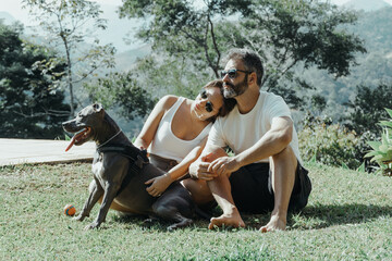 Brazilian family formed by man, woman and dog admiring the nature and mountains of Petrópolis, in...