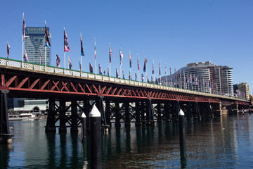 Modern building and iron bridge with any flag at Sydney
