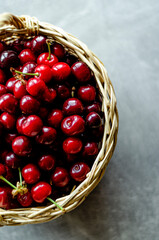 basket with ripe cherries top view