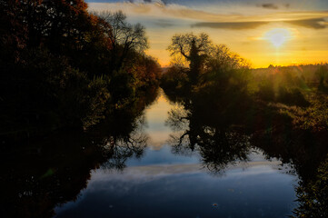 River View, Looking into Sun With River Bank Silhouette