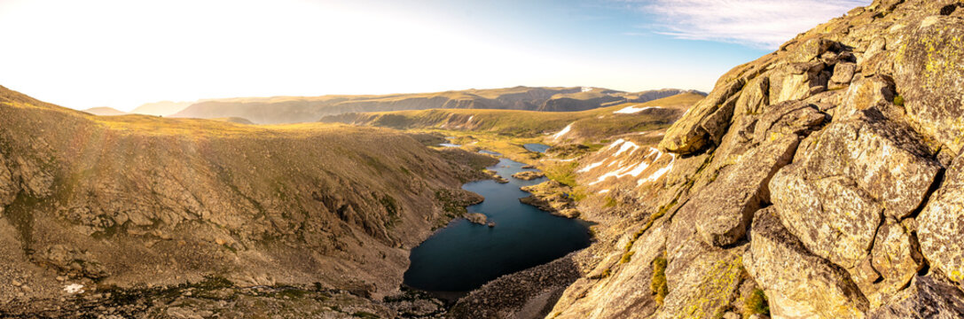 Sunrise over alpine lakes in the mountains panorama