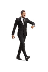 Businessman walking fast and checking time