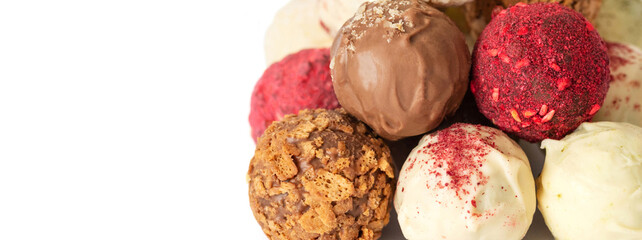 Homemade candies isolated on a white background close up. Energy balls with chocolate, nuts, berries and karkade. Superfood. Copy space.