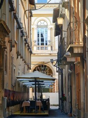 Fototapeta na wymiar Tables on a Street of the Historical Center of L'Aquila, Abruzzo, Italy