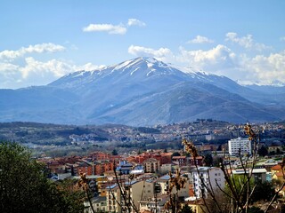 A Blue Mountain with the Snowy Top Surrounded by the City of L'Aquila, Abruzzo, Italy