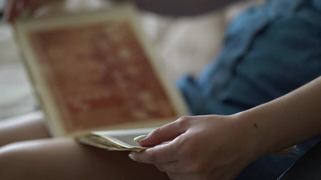 Woman looking at old photo album of her family