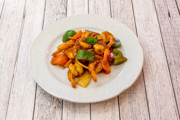 Fried peeled shrimp with vegetables and hot sauce cooked with the recipe of a Chinese chef