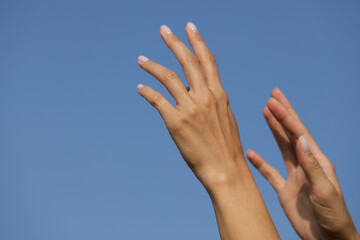 Fototapeta na wymiar hands reaching for the sky