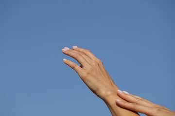 Fototapeta na wymiar Finger. hands on sky background
