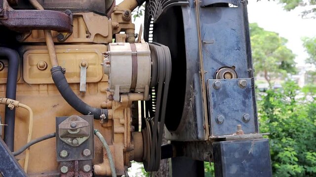 The belt is spinning. The large engine belt assembly is running along with the traction motor and radiator rotor.