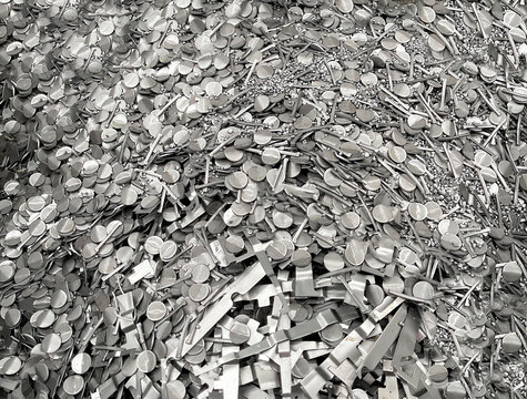 pile of steel scrap, scrap from cold stamping sheet metal cutting process, punching waste, material for recycling