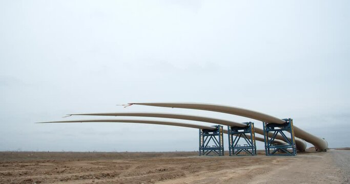 Pieces of tape on the tips of wind turbine blades are flailing in the wind, 4k