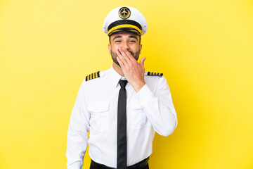 Airplane arab pilot man isolated on yellow background happy and smiling covering mouth with hand