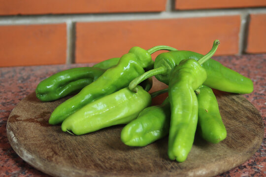 Closeup shot of Friarelli peppers on a wooden board