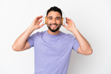 Young arab man isolated on white background listening music