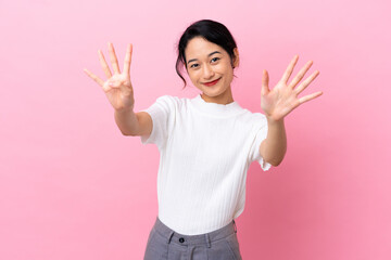 Young Vietnamese woman isolated on pink background counting nine with fingers