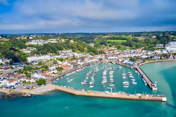Aerial drone image of St Aubn's Harbour and Village at high tide in the sunshine. Jersey Channel Islands