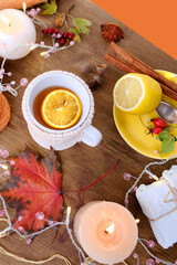 beverage, hot drink in a mug, leaves, foliage, garland, candles, top view of wooden table, good weather concept, outdoor tea party, cozy autumn mood
