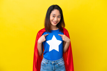 Super hero Vietnamese woman isolated  on yellow background with surprise facial expression