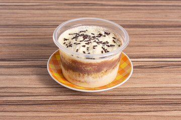 nutella pot cake with milk nest on wooden background