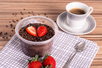 brigadeiro pot cake with strawberry on wooden background