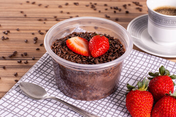 brigadeiro pot cake with strawberry on wooden background