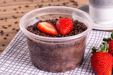 brigadeiro pot cake with strawberry on wooden background