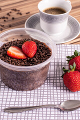 brigadeiro pot cake with strawberry on wooden background