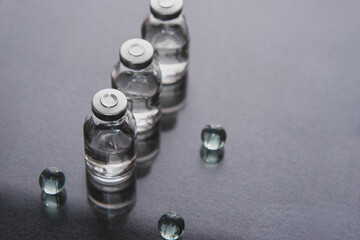 Set of transparent medical glass bottles of liquid. Concept of medical, pharmaceutical, technology. Covid-19 cure, coronavirus vaccine. Copyspace, selective focus