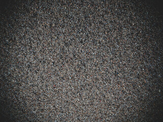 small sand grains of sand top view dark designer background