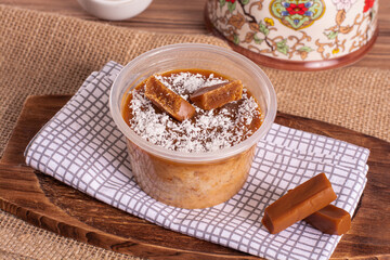 dulce de leche cake on wooden background