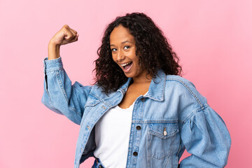 Teenager cuban girl isolated on pink background doing strong gesture