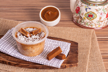 dulce de leche cake on wooden background