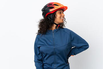 Teenager cyclist woman isolated on white background looking to the side and smiling
