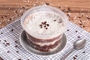 coconut and chocolate pot cake on wooden background