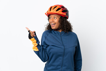 Teenager cyclist woman isolated on white background intending to realizes the solution while lifting a finger up