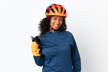 Teenager cyclist woman isolated on white background pointing to the side to present a product