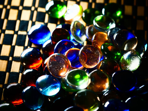 Closeup Of Bright Colorful Clear Board Game Tokens With Light Reflecting On Them