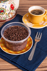 cake in brigadeiro pot on wooden background