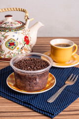cake in brigadeiro pot on wooden background