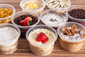 cakes in pot of various flavors on wooden background