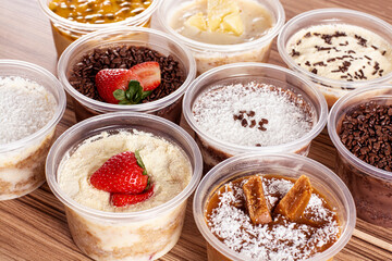 cakes in pot of various flavors on wooden background