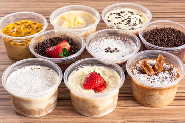 cakes in pot of various flavors on wooden background