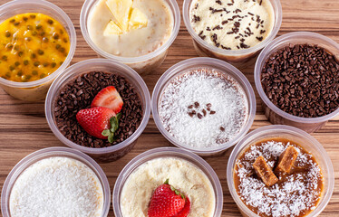 cakes in pot of various flavors on wooden background